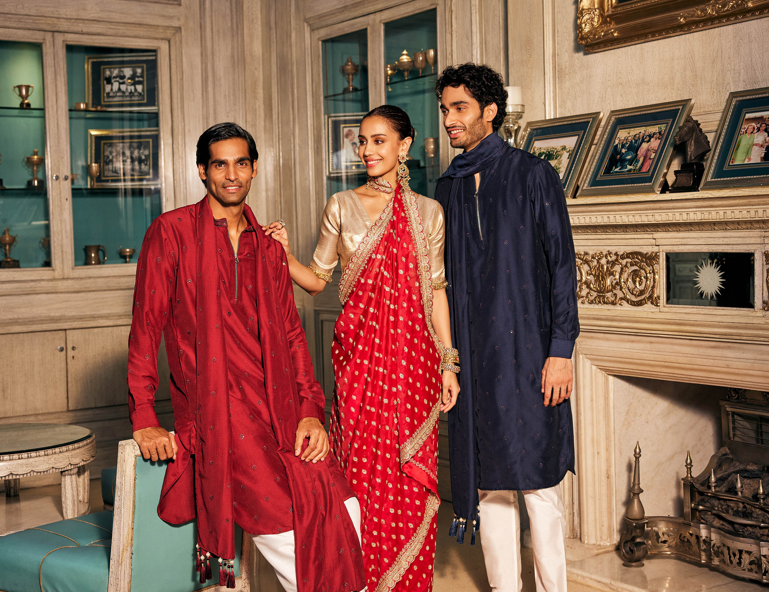 Two men wears Red and Blue embroidary kurta pajama and women wears stylish red saree